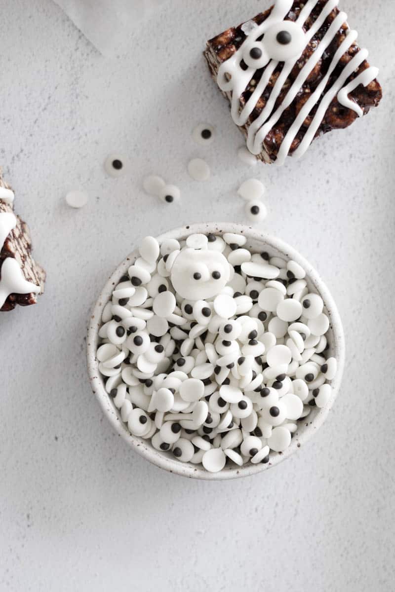 Edible candy eyeballs in a white bowl.