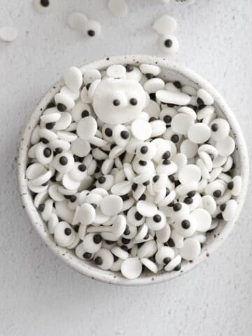 Edible googly eyes in a white bowl.