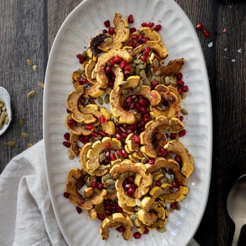 Roasted Delicata Squash with Balsamic and Pomegranate Seeds on a platter