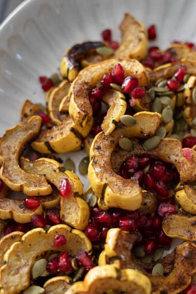 Closeup of Roasted Delicata Squash with Balsamic and Pomegranate Seeds