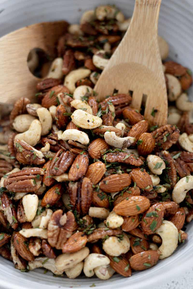 Closeup of the olive oil and herbs mixed in with the nuts. 