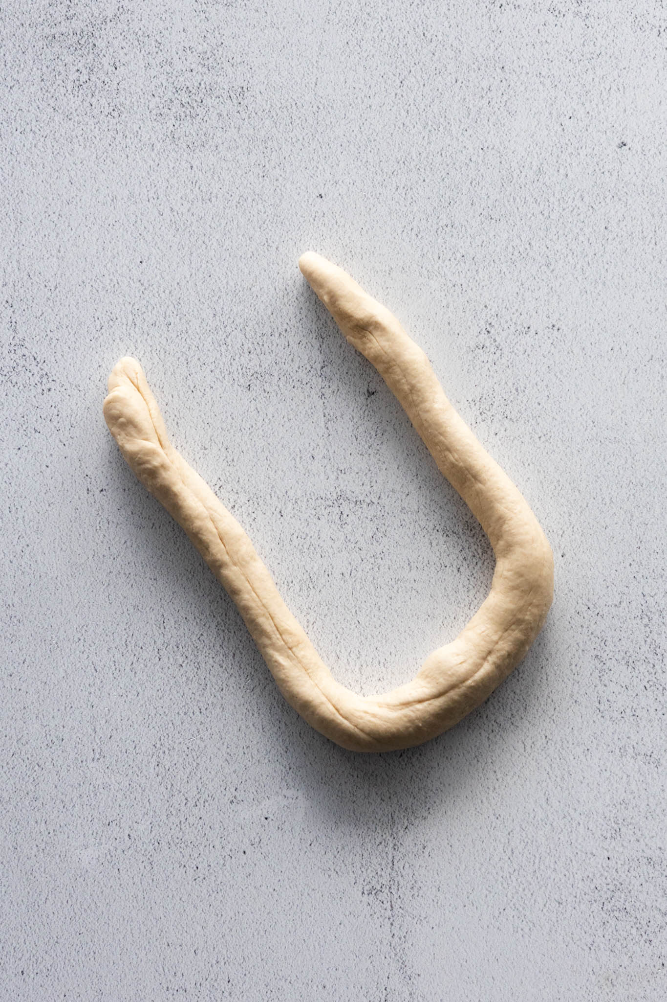 Create a U-shaped rope to make the pretzel shape.