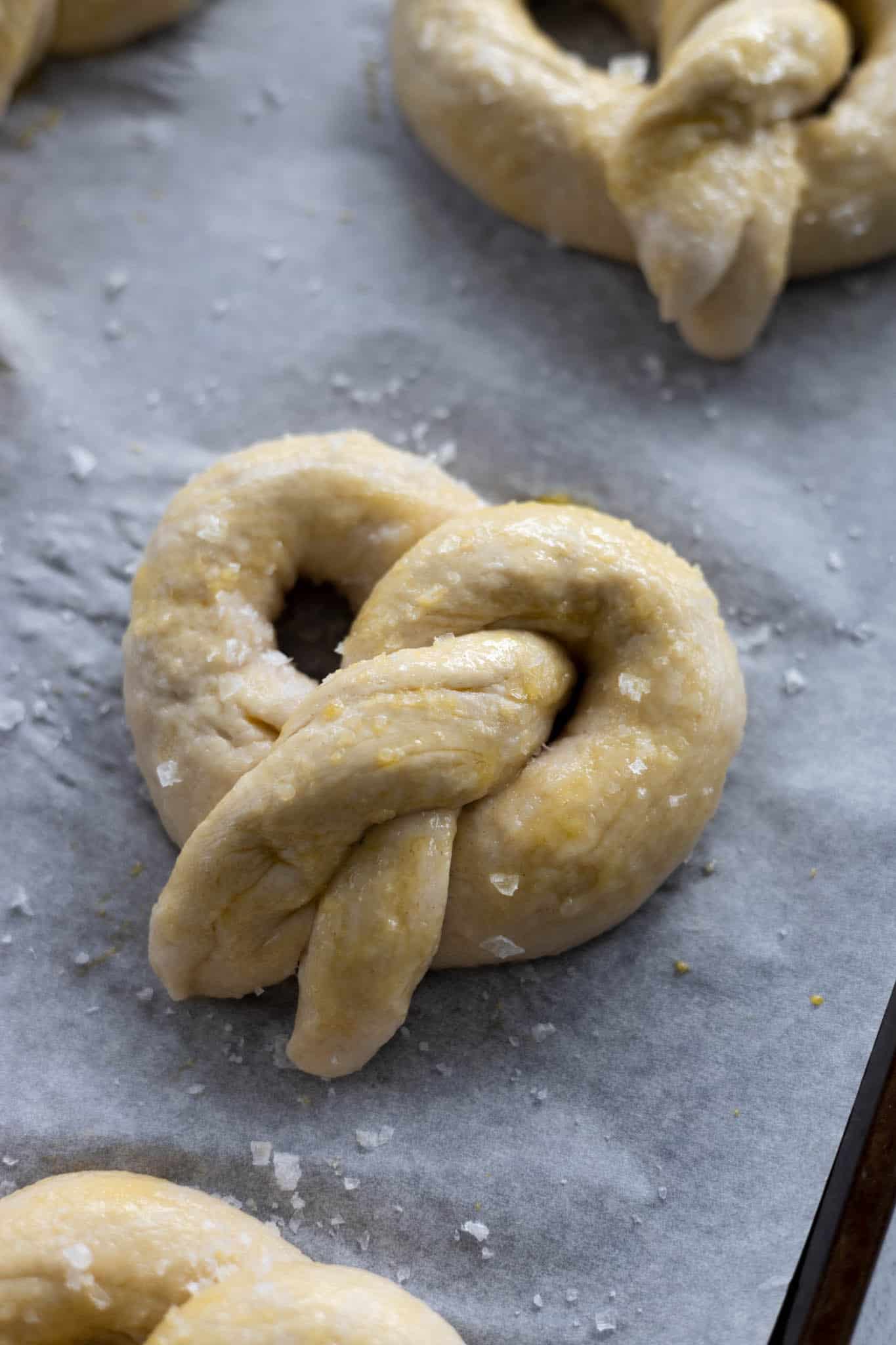 Uncooked pretzels with egg wash and sea salt.