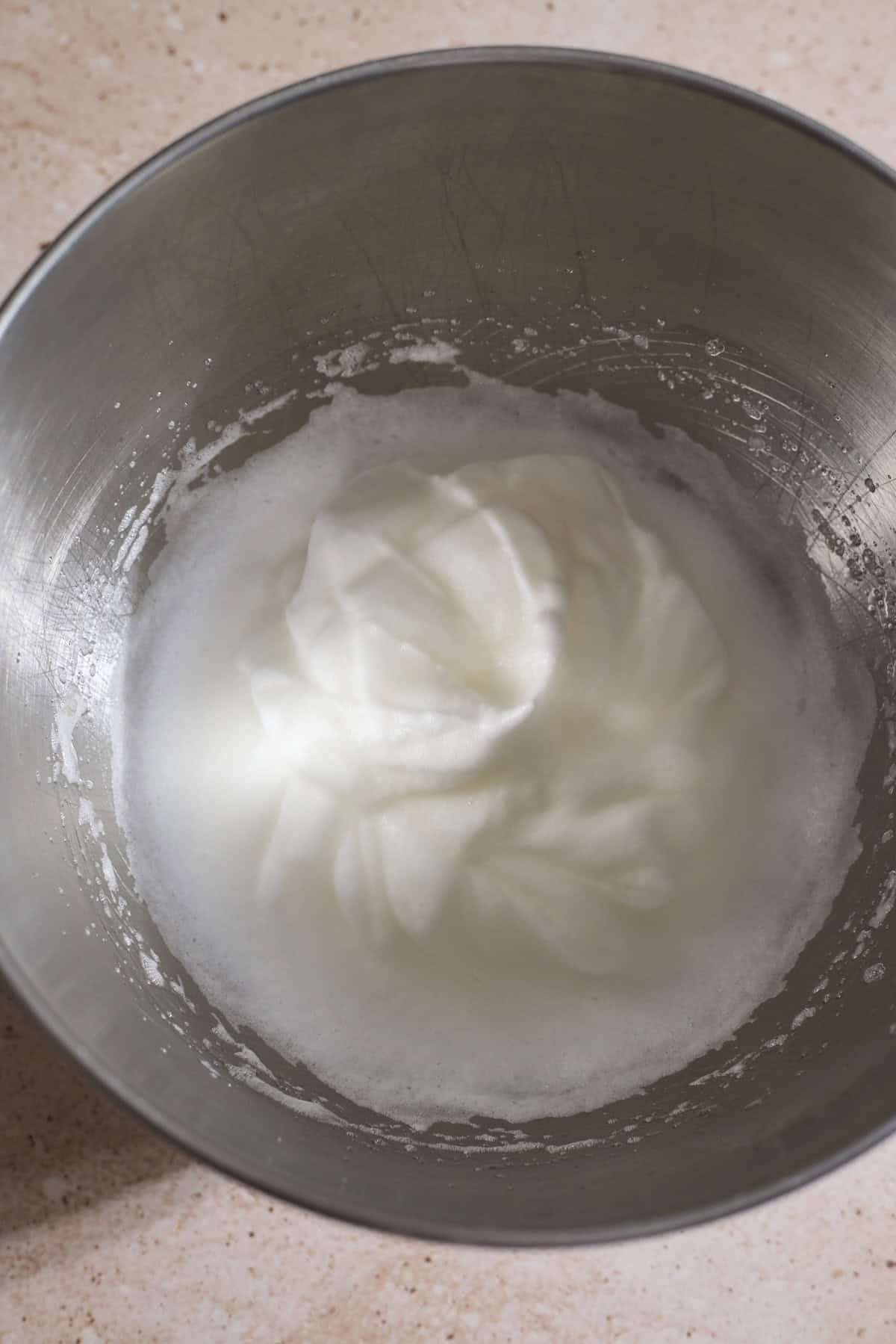 Whipped egg whites in a large bowl. 