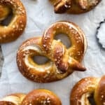 Sourdough discard pretzels on white parchment paper.