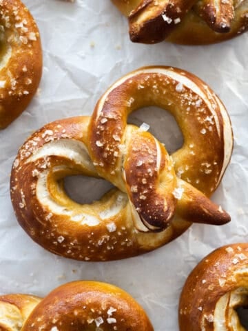 Sourdough discard pretzels on white parchment paper.