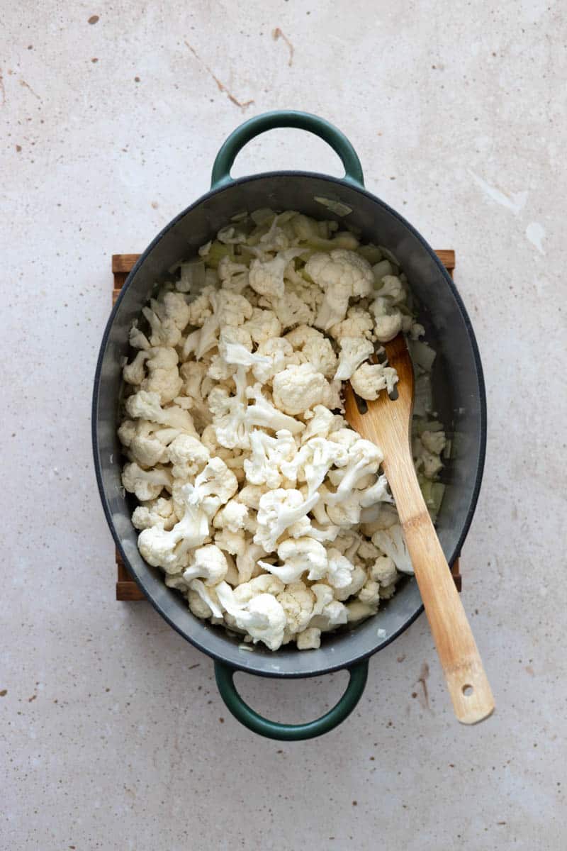 Cauliflower added to the soup pot.