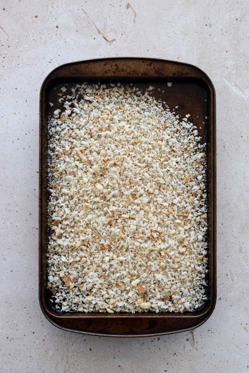 Breadcrumbs on a baking sheet.