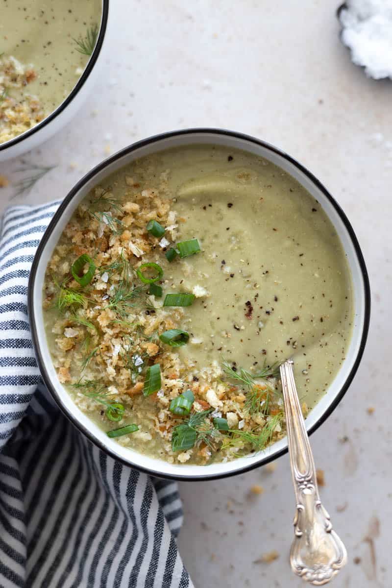 Spinach Cauliflower Soup in a bowl with a spoon and a blue and white striped linen.