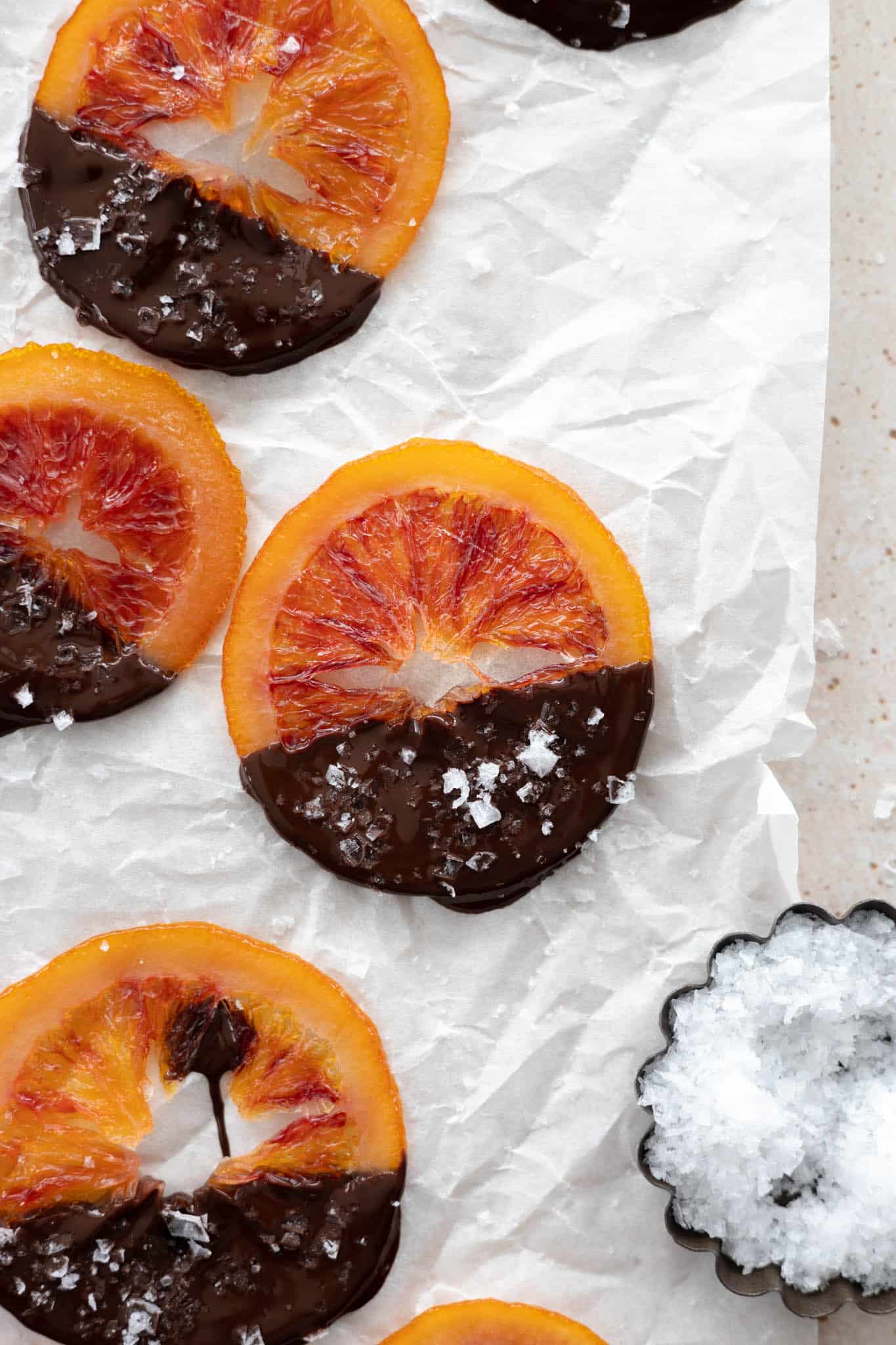 Candied Blood Oranges with sea salt on a piece of parchment paper. 