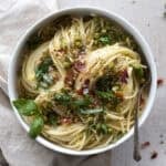 Pasta with Peas and Prosciutto in a white bowl.