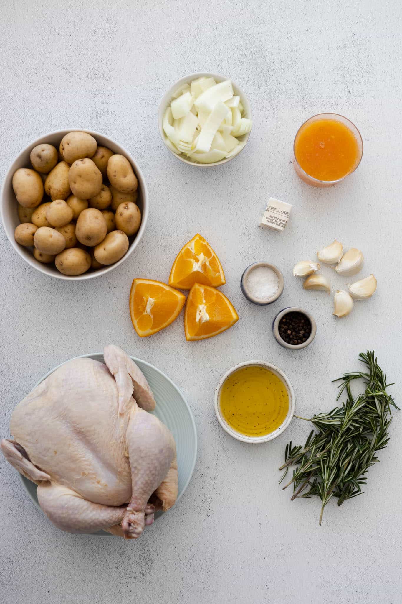 Ingredients for Citrus & Herb Whole Roasted Chicken on a table. 