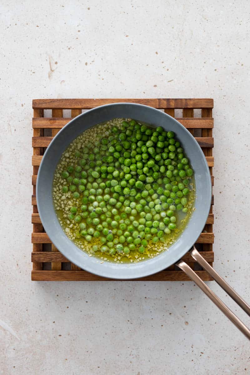 Peas in a small skillet with olive oil.