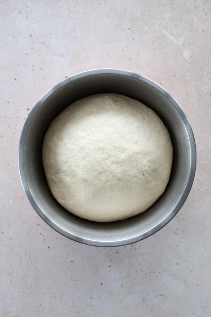 The dough after it has risen and doubled in size in the bowl.