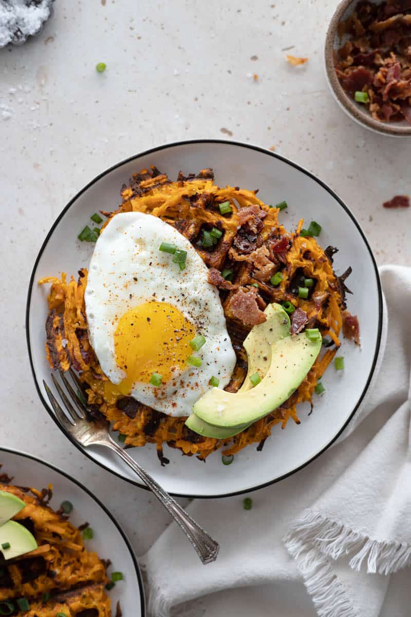 Dairy-Free Sweet Potato Waffle on a plate with a fried egg and avocado slices.