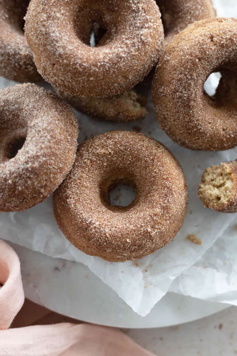 Baked Cinnamon Sugar Donuts in a stack on a marble platter.