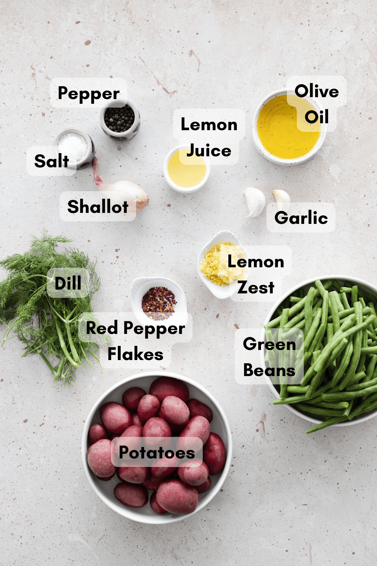 Ingredients for Green Beans and Potatoes in small bowls on a table.