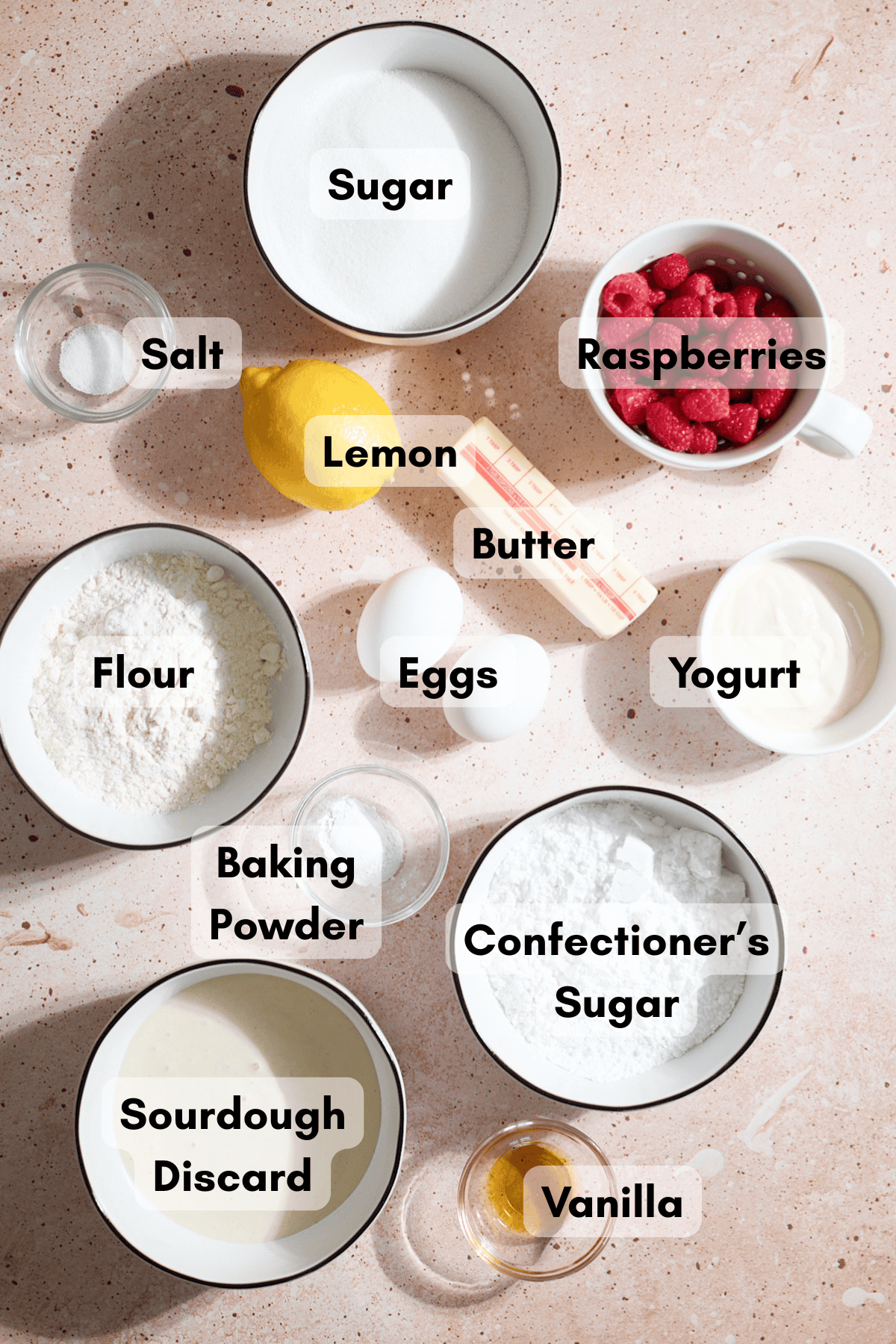 Ingredients for Sourdough Lemon Raspberry Loaf Cake in small bowls.