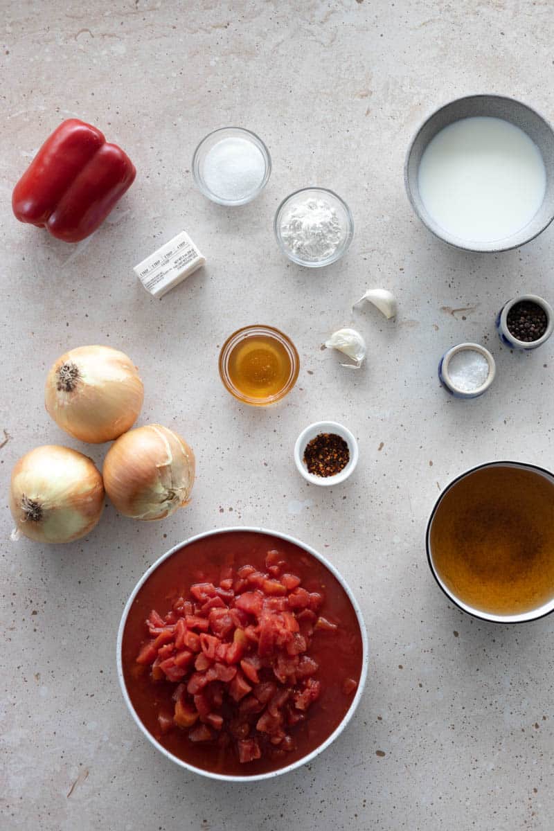 Ingredients for Tomato and Roasted Red Pepper Soup in small bowls. 