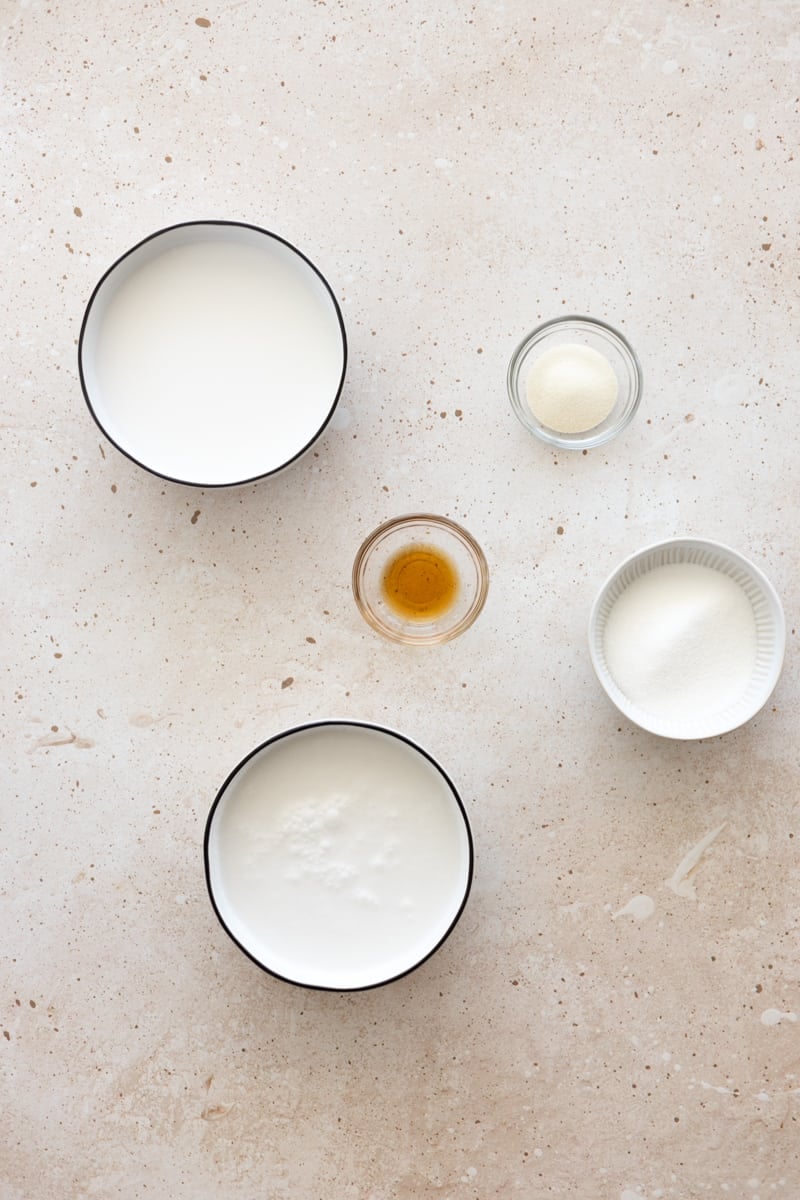 Ingredients for dairy-free panna cotta in small bowls. 