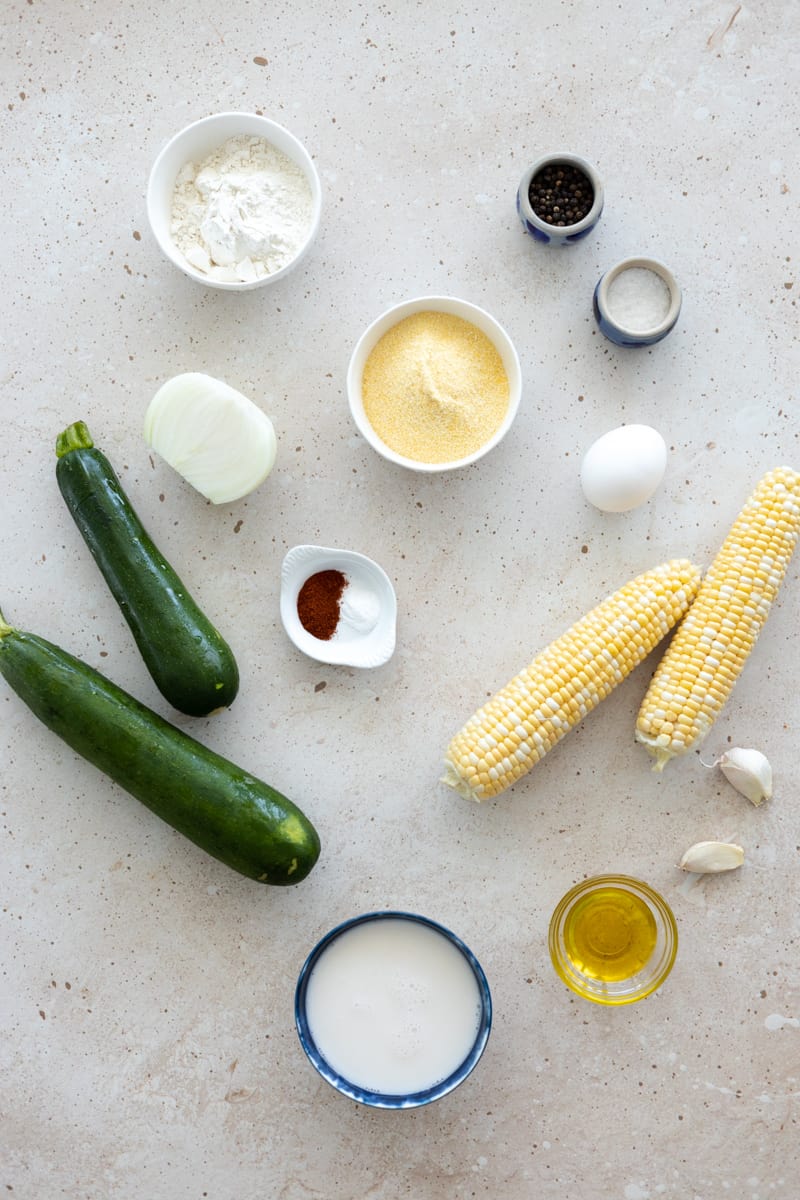 Ingredients for Zucchini and Sweetcorn Fritters in small bowls. 