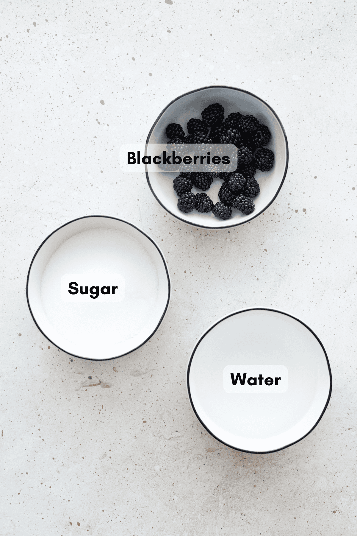 Ingredients for blackberry simple syrup in small bowls.