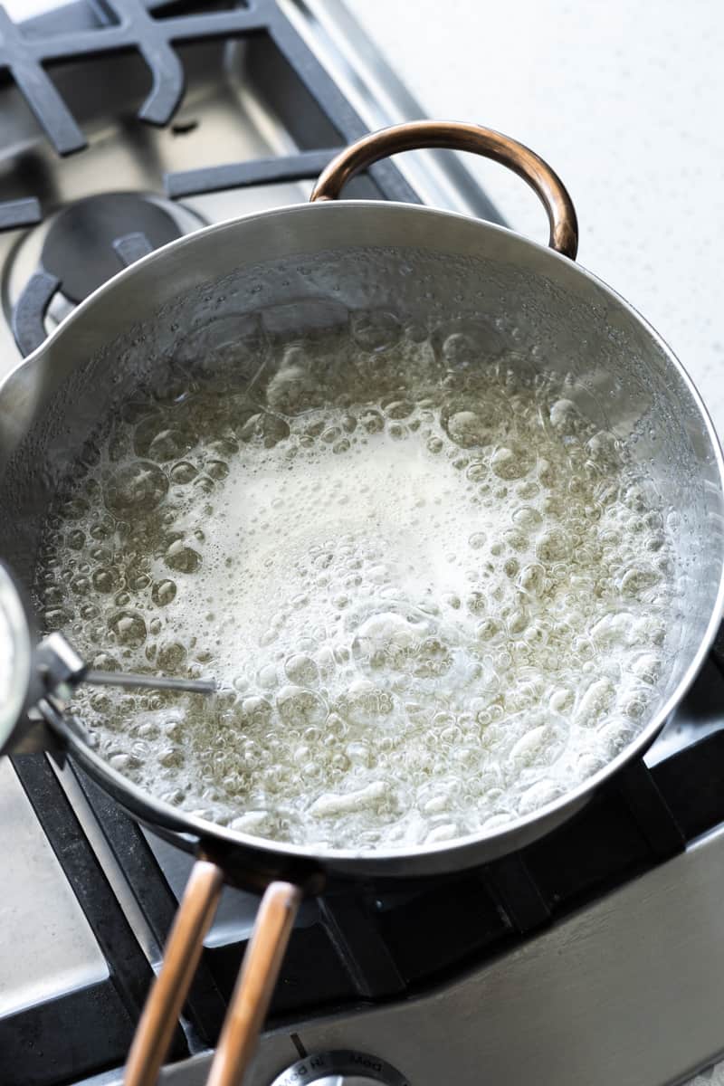 The sugar mixture boiling in the saucepan. 