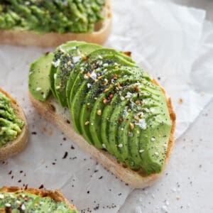 A closeup of avocado toast with everything bagel seasoning.