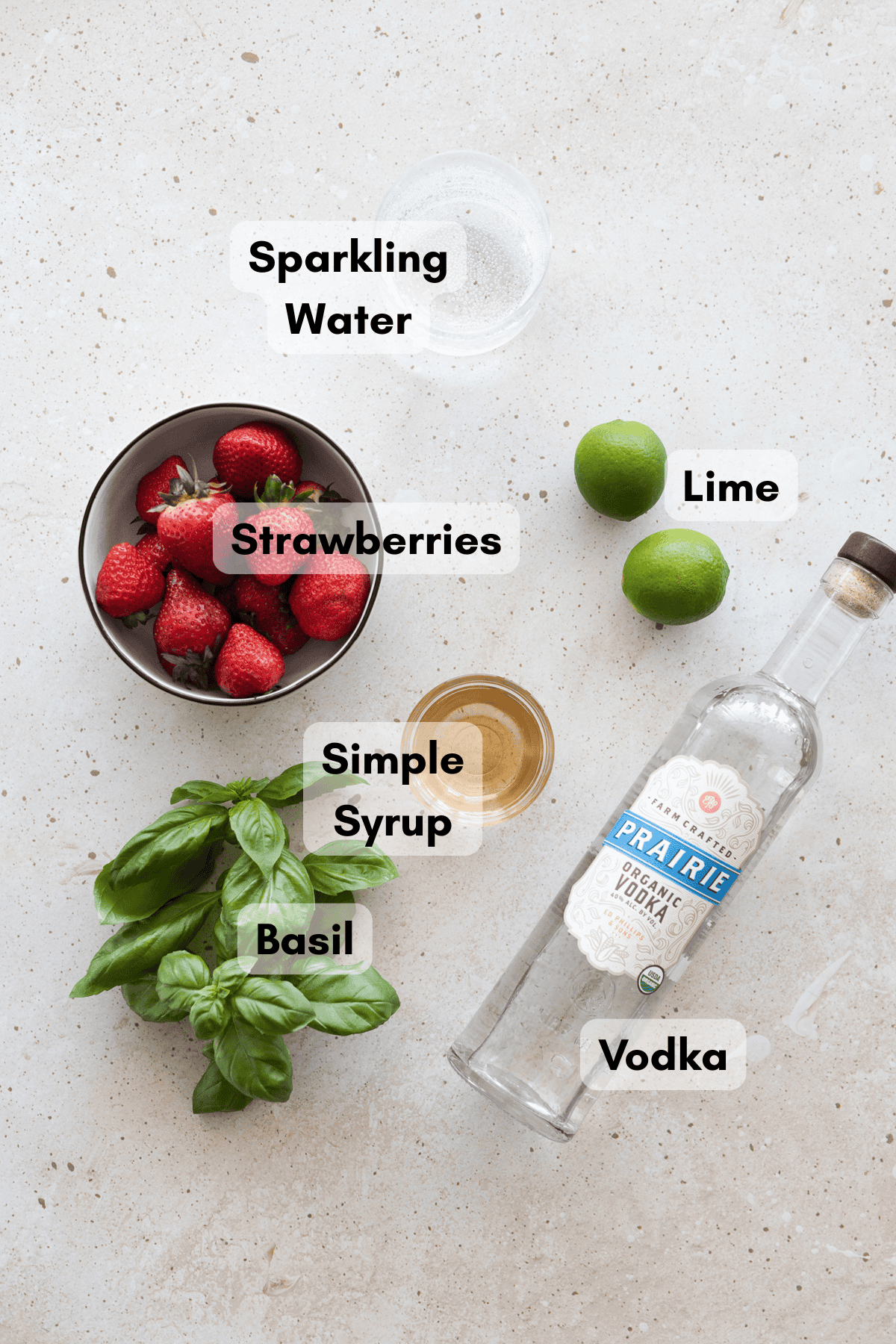 Ingredients for a strawberry basil vodka cocktail.