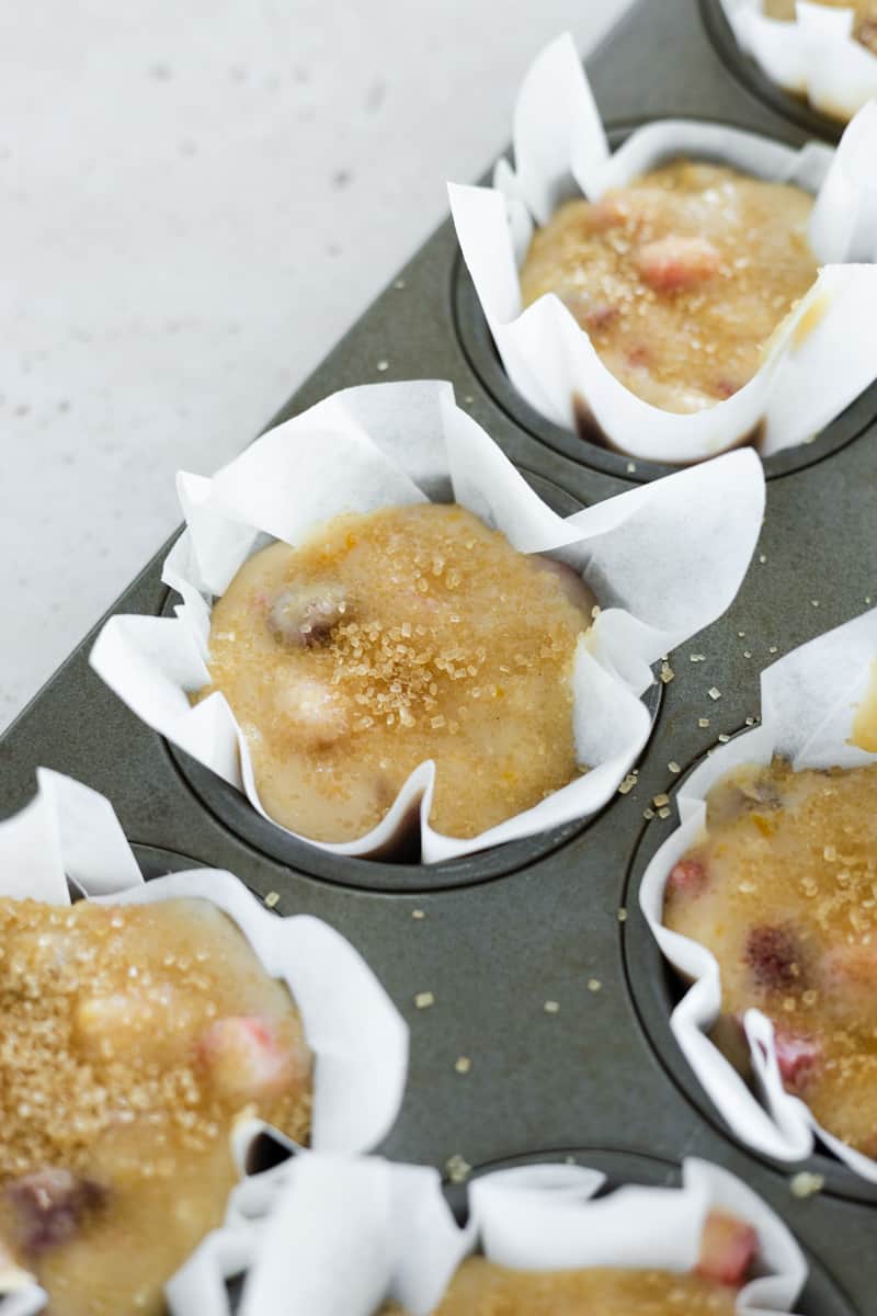 Batter in the parchment paper lined muffin cups, ready to bake.