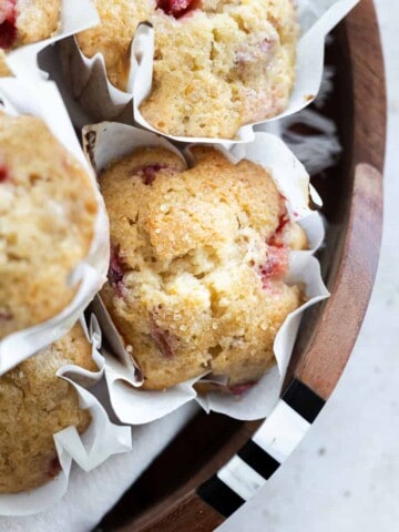 A pile of Strawberry Rhubarb Muffins on a tray.