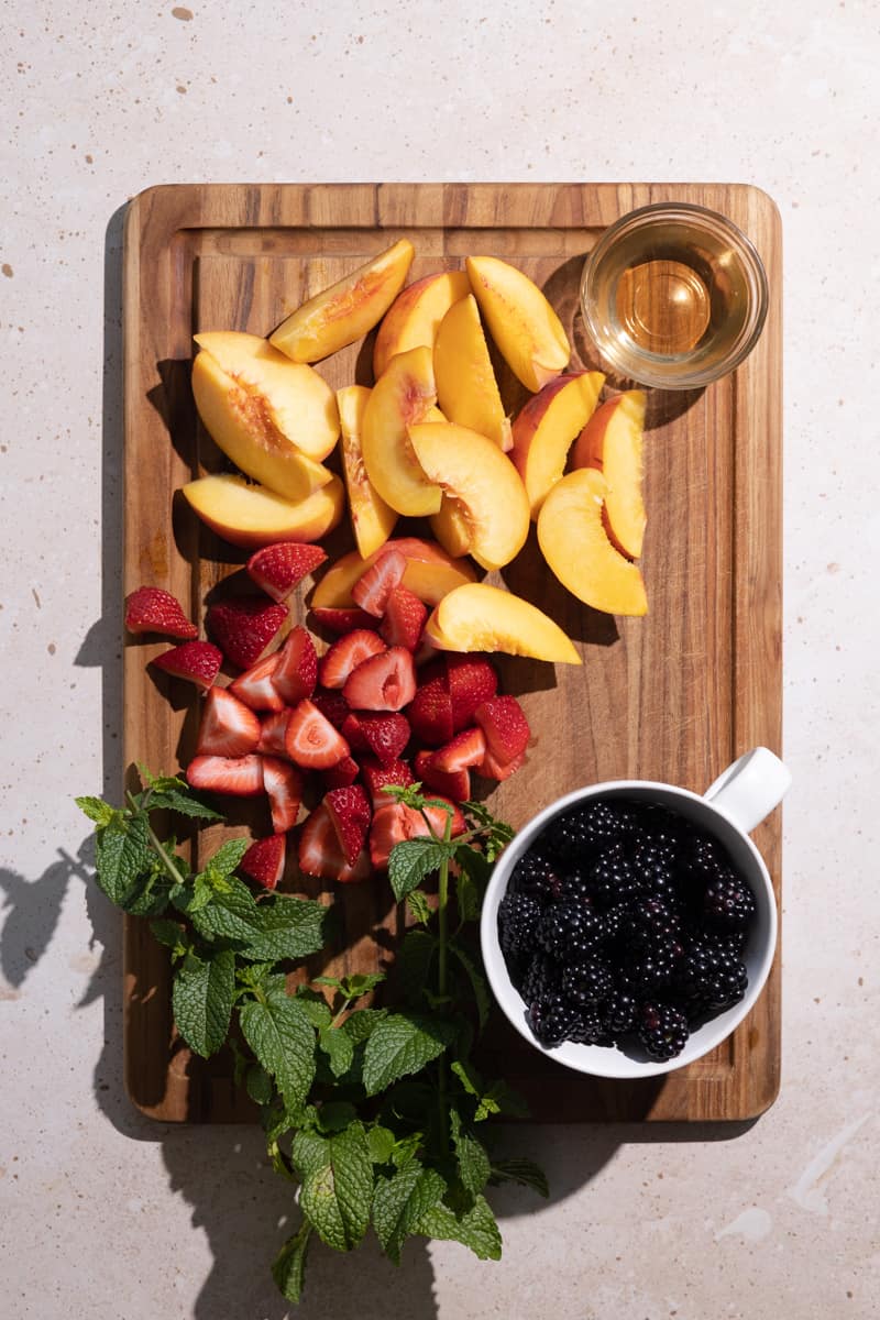 Sliced fruits on a wooden cutting board. 