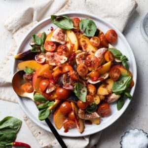 Peach and Prosciutto Salad on a white platter.