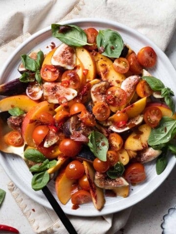 Peach and Prosciutto Salad on a white platter.