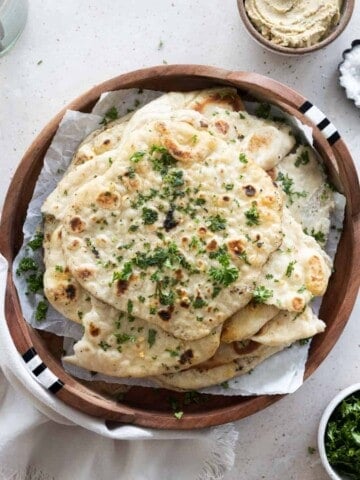 Sourdough discard naan on a wooden tray.