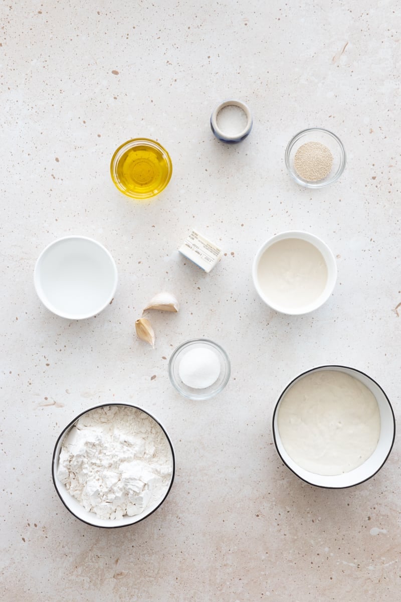 Ingredients for sourdough discard naan in small bowls.