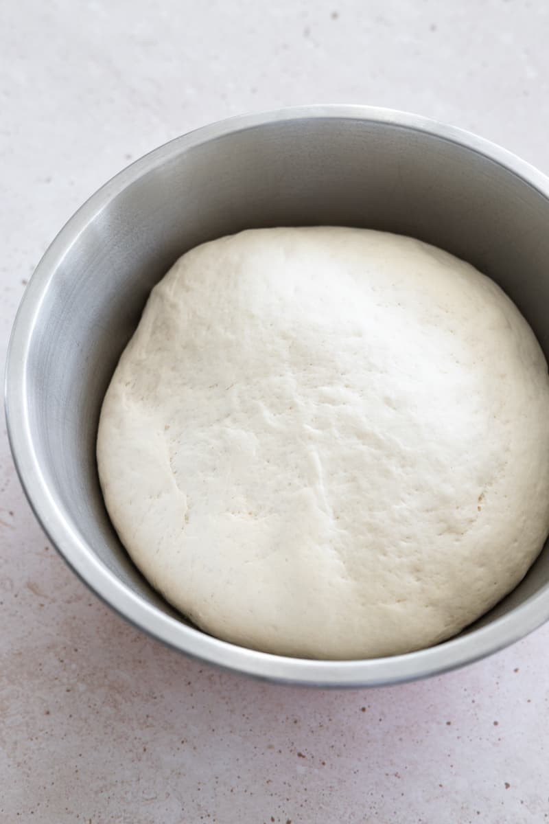 Dough rising in a large bowl. 