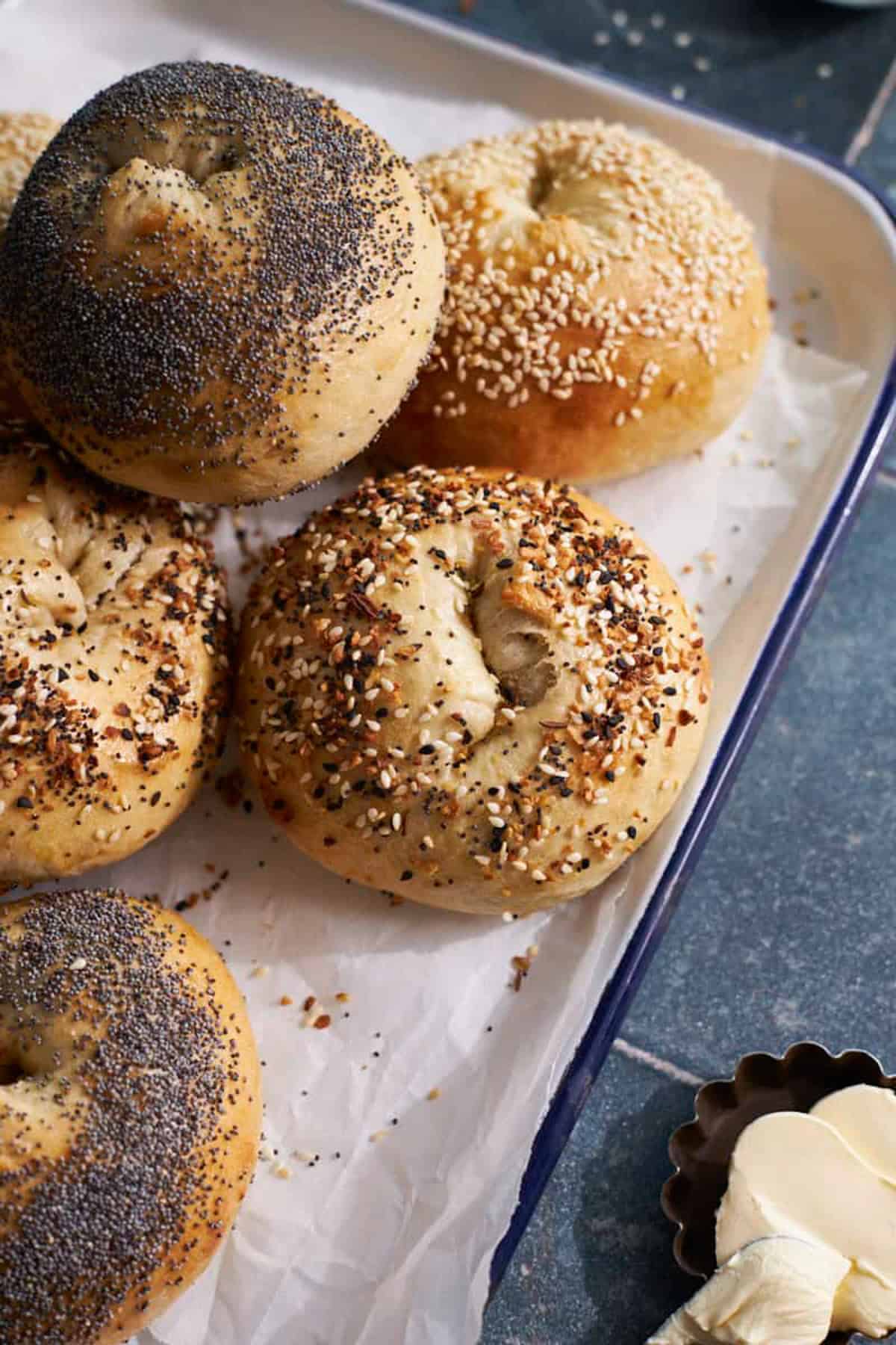 A pile of Sourdough Discard Bagels on a white tray.