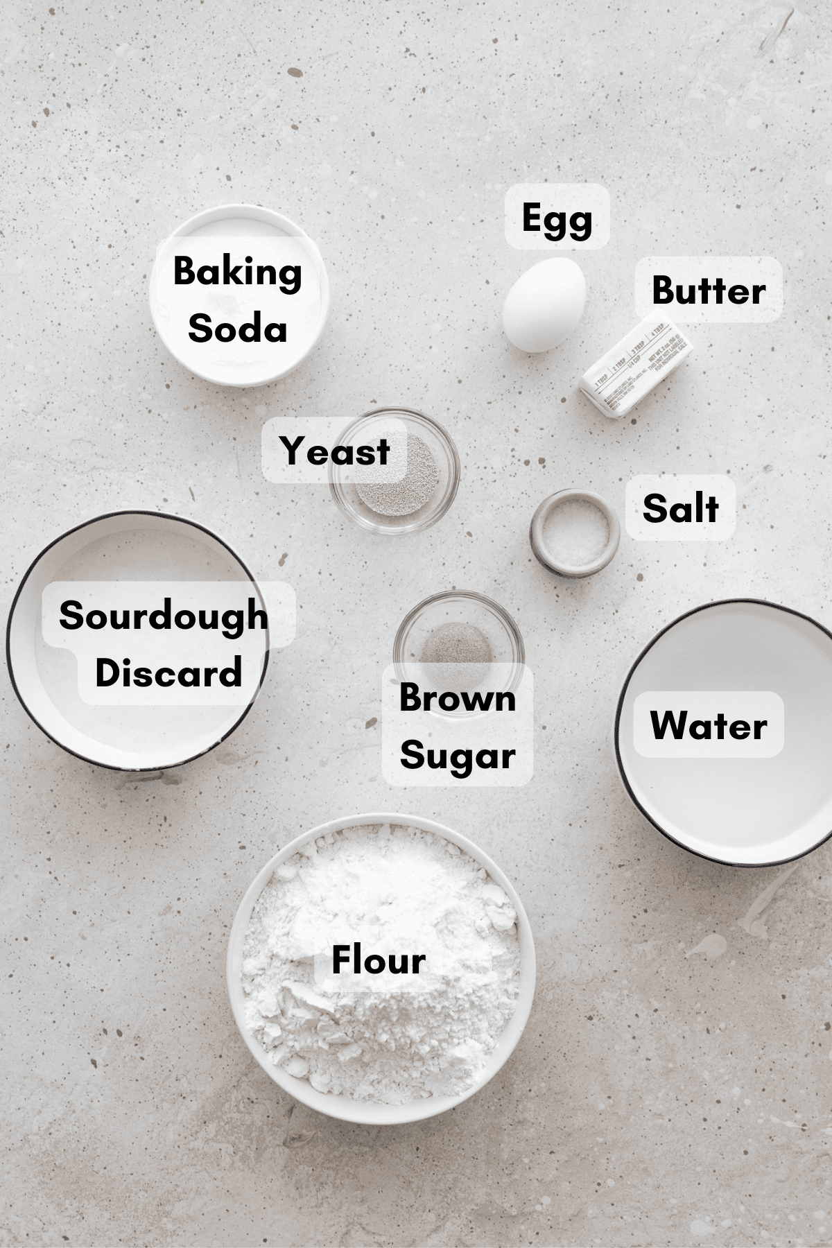 Ingredients for Sourdough Discard Pretzel Buns in small white bowls. 
