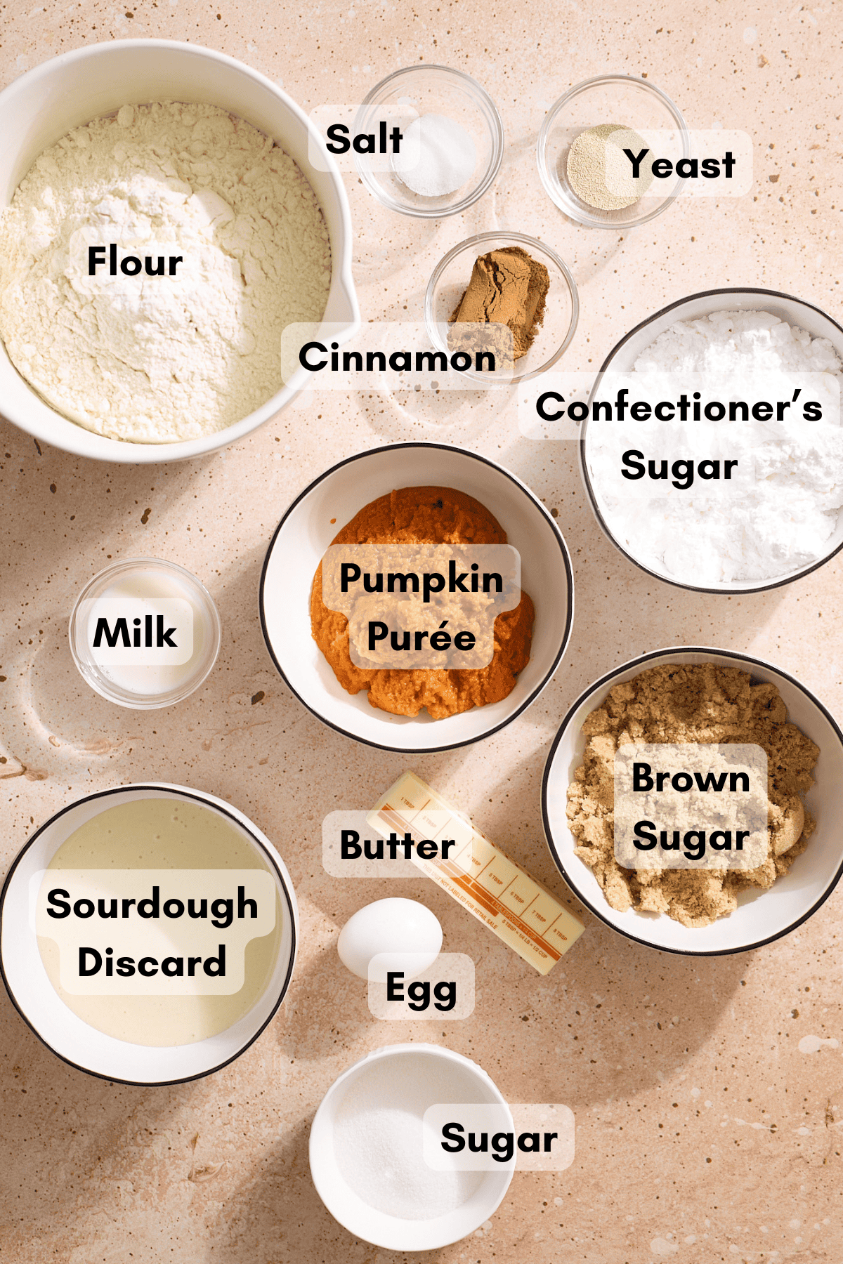 Ingredients for Sourdough Discard Pumpkin Cinnamon Rolls in small bowls. 