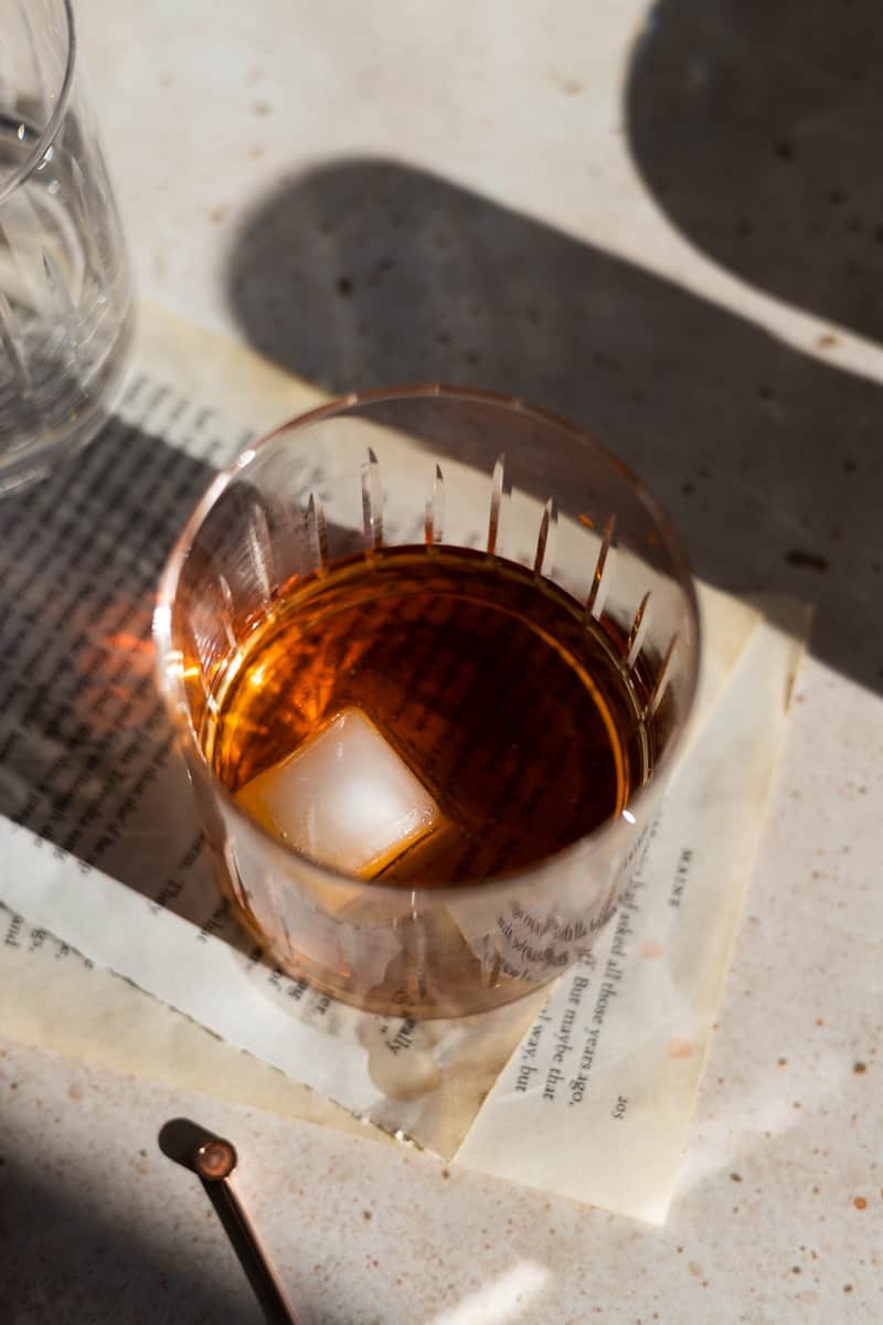 An ice cube added to the cocktail glass. 