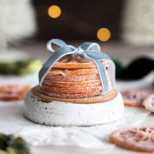 Candied orange slices in a stack with a blue ribbon.