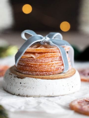 Candied orange slices in a stack with a blue ribbon.