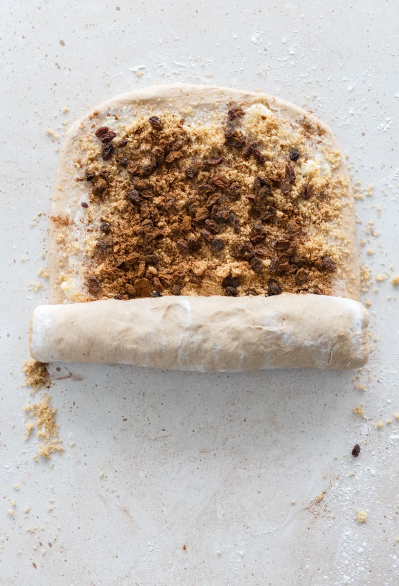 Dough being rolled from the short end of the rectangle. 