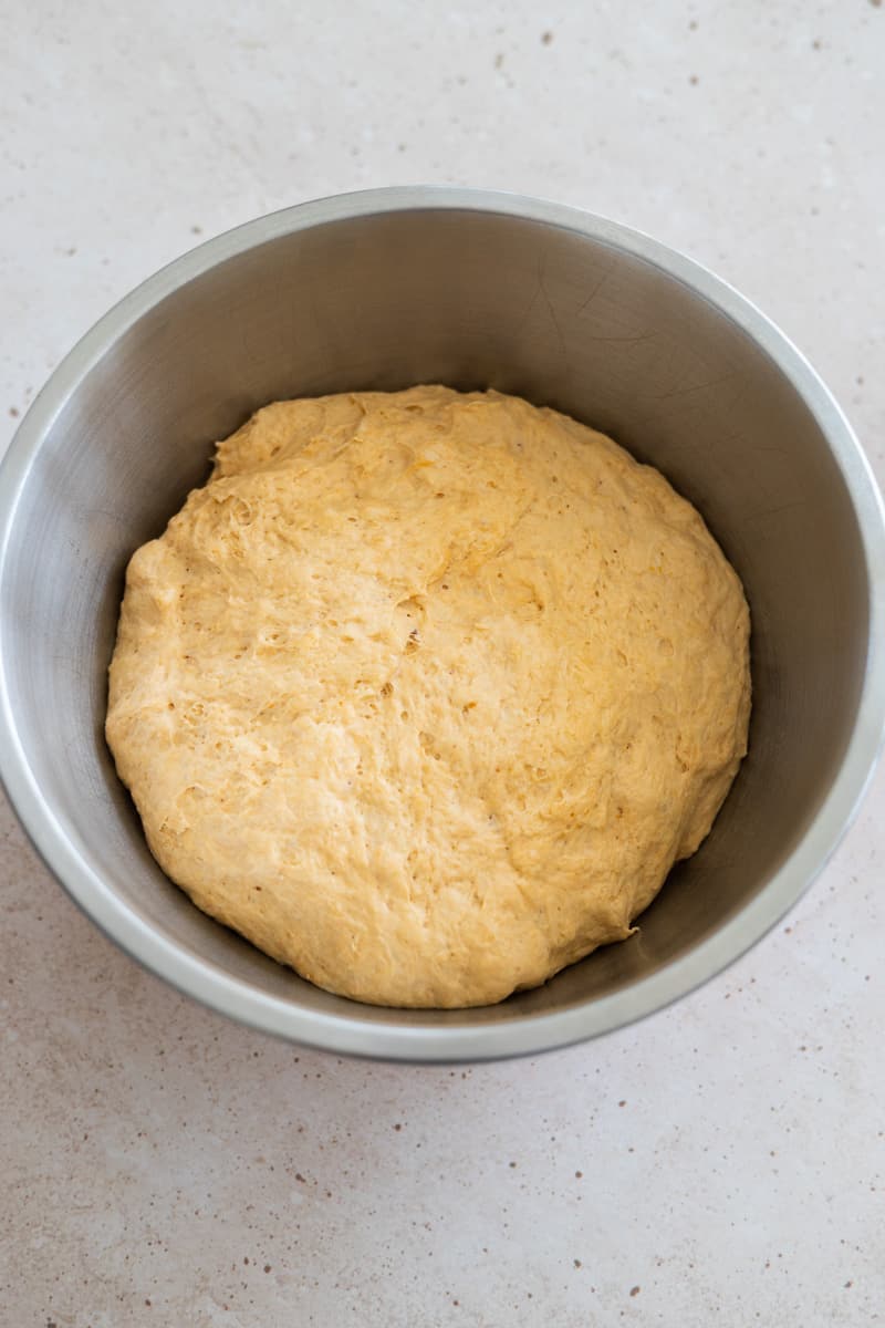 Dough in a metal bowl after first rise. 