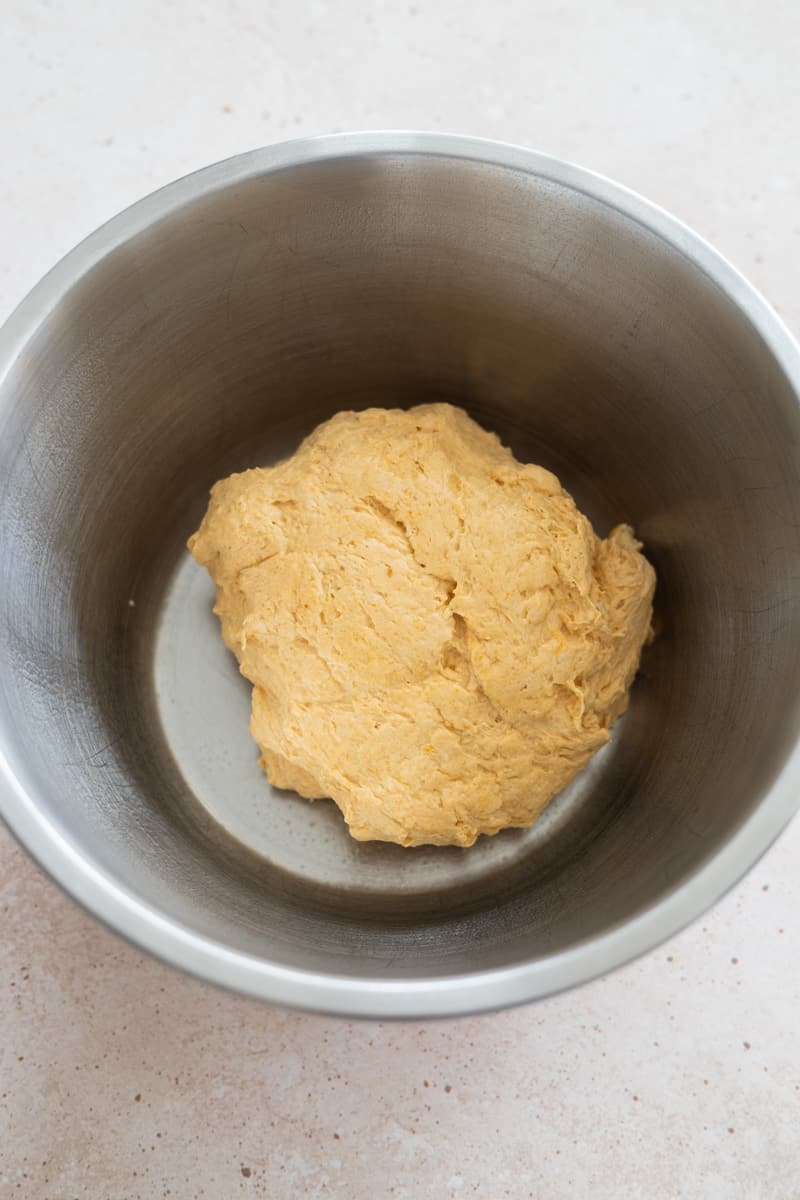 Mixed dough in a metal bowl for the first rise. 