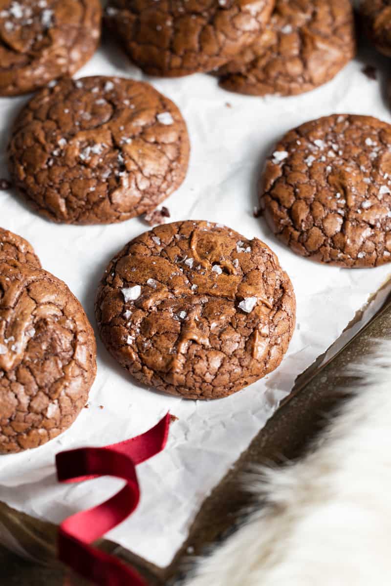 Chocolate espresso cookies on a tray with a red ribbon.