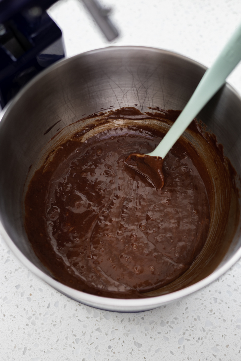 Chocolate mixture in the bowl of a stand mixer. 