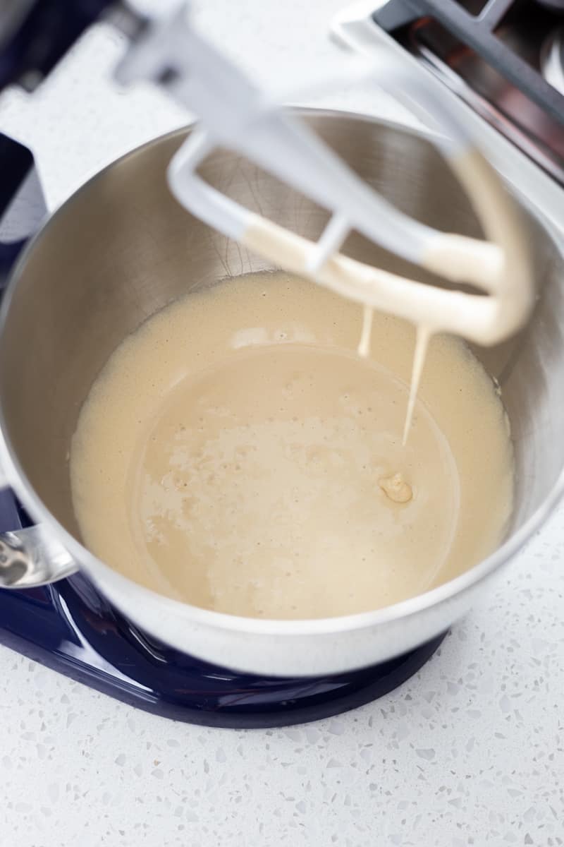 Sugar and egg creamed together in bowl of a stand mixer. 
