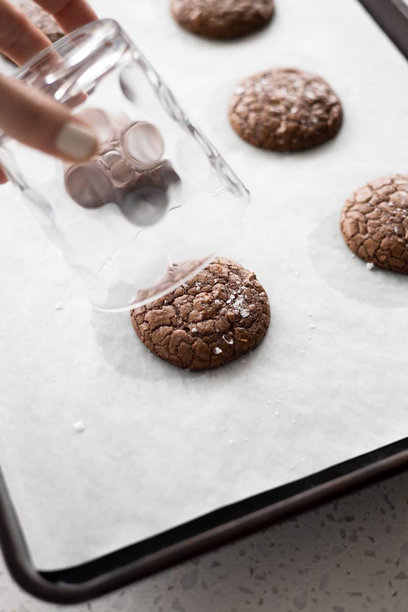 Using a glass cup to swirl the warm cookies to make them perfectly round. 